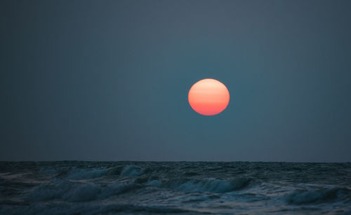 Scenic view of sea against clear sky during sunset