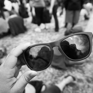 Close-up of man holding sunglasses