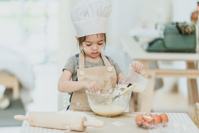 Girl holding ice cream at home