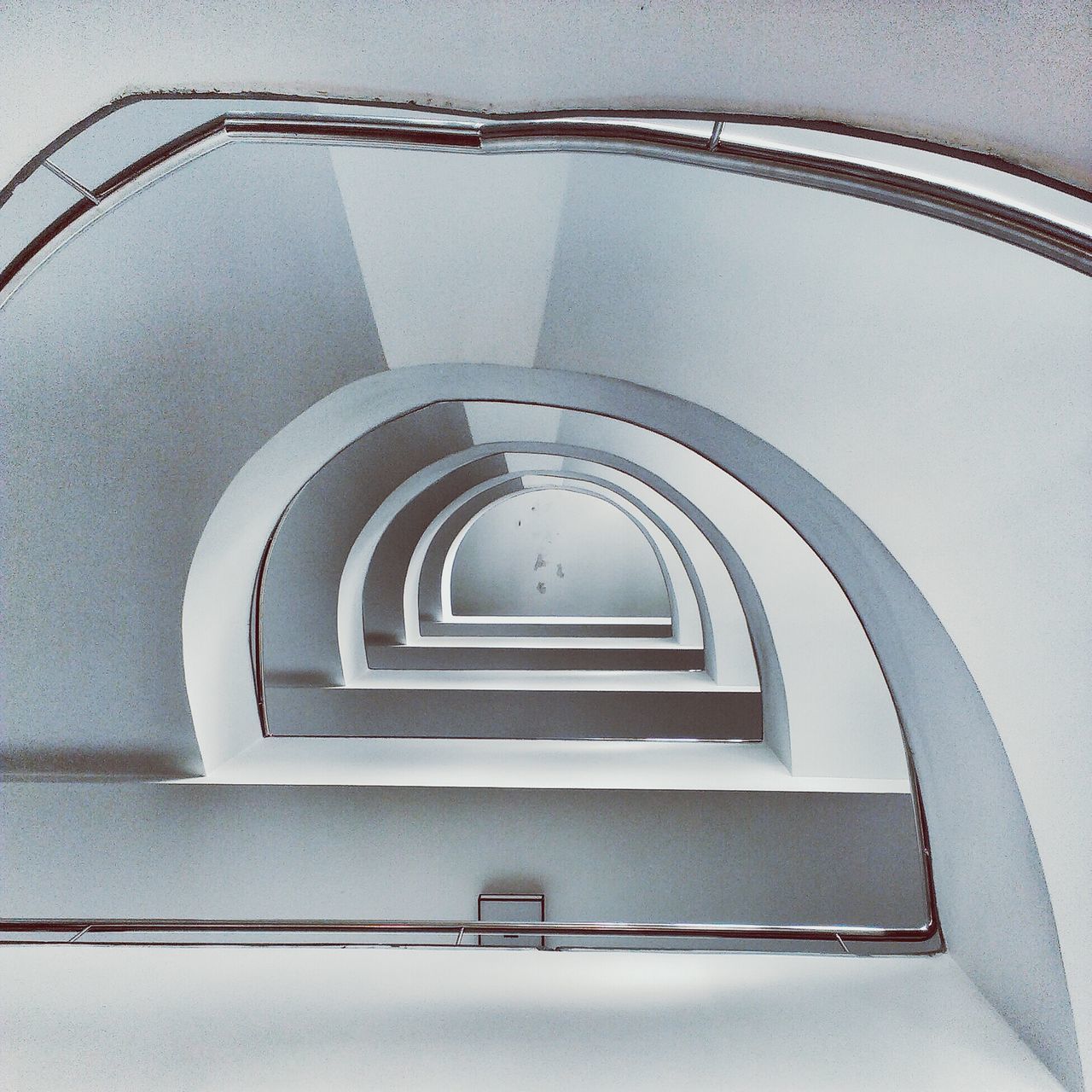 architecture, built structure, building exterior, low angle view, staircase, steps, steps and staircases, railing, building, spiral staircase, arch, directly below, spiral, stairs, no people, day, architectural feature, pattern, wall - building feature, indoors