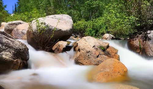 Scenic view of waterfall against sky