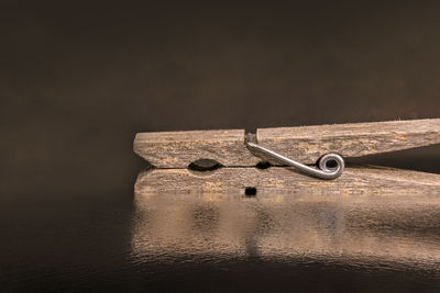 Close-up of metallic structure in sea against wall