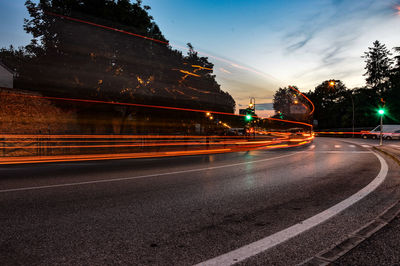 Light trails on road in city at night