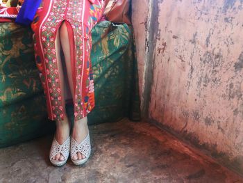 Low section of woman standing on tiled floor