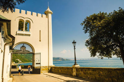 Building by sea against sky