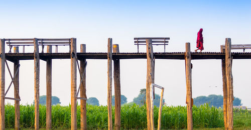 Wooden fence on field against clear sky