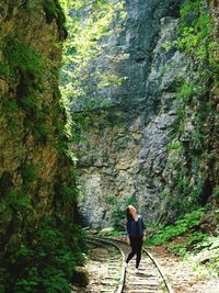 Woman standing on rock in forest