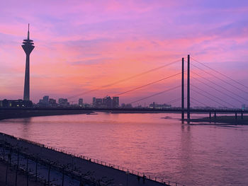 View of bridge over river against cloudy sky