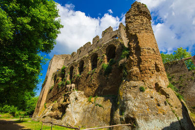 Low angle view of old ruins against sky