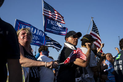 Group of people standing in front of flags