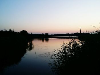 Scenic view of calm lake at sunset
