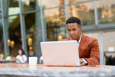 Businessman using laptop in cafe