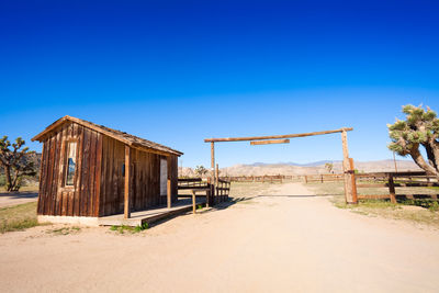 Abandoned built structure on beach against clear blue sky