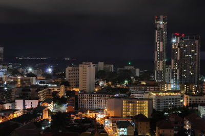 High angle view of illuminated buildings against sky at night