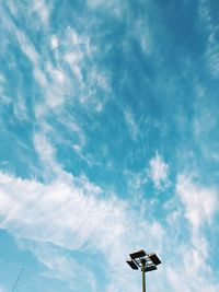 Low angle view of street light against cloudy sky