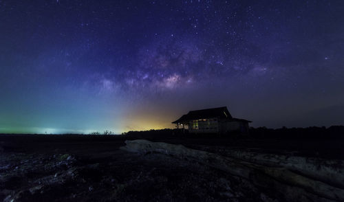 Built structure on landscape against sky at night