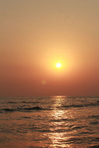 Scenic view of sea against orange sky