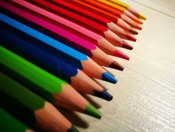 Close-up of colorful pencils arranged on table