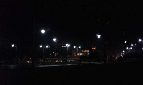 Illuminated lights against sky at night