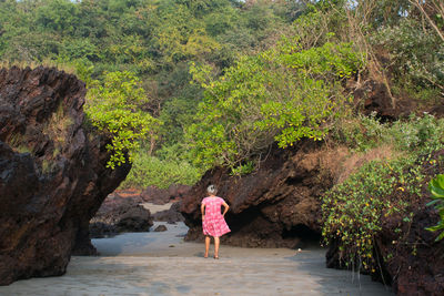 Rear view of woman walking on mountain