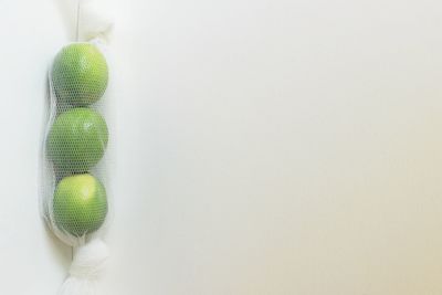Close-up of multi colored ball hanging against white wall