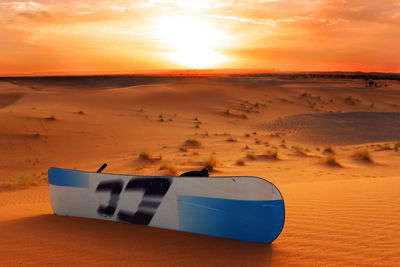 Sandboard at desert during sunset