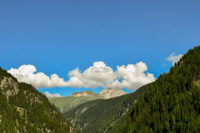Scenic view of mountains against blue sky