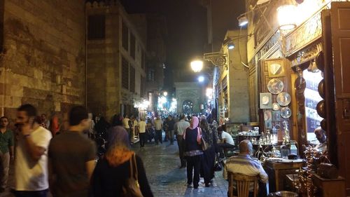 People in illuminated city at night