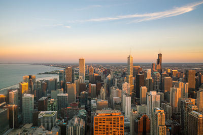 Aerial view of cityscape against sky during sunset