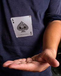 Midsection of man playing poker