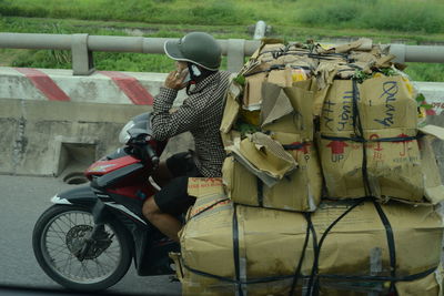 Rear view of people on motorcycle