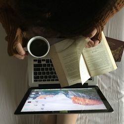 Directly above view of person holding coffee cup on table at home