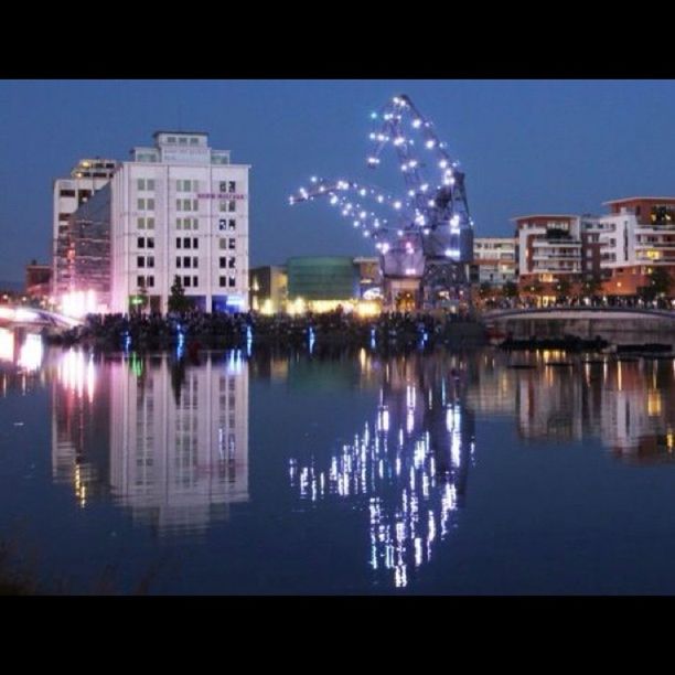 architecture, building exterior, reflection, water, built structure, city, illuminated, waterfront, night, clear sky, river, blue, cityscape, transfer print, modern, sky, auto post production filter, building, skyscraper, city life