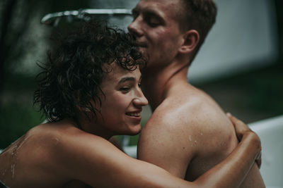 Couple in bathtub outdoors