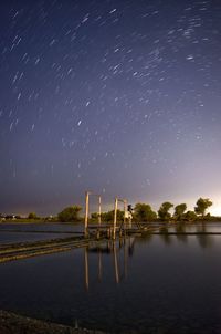 Scenic view of lake against sky at night