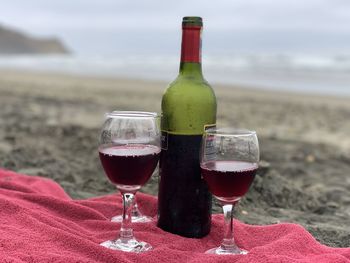 Glass of wine bottles on beach