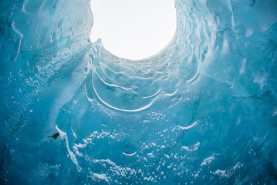 Close-up of frozen sea against blue sky