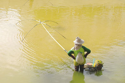 High angle view of man fishing in lake