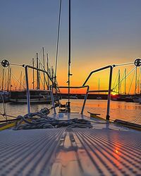 Boats in sea at sunset