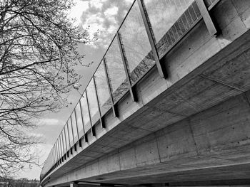 Low angle view of bridge and buildings against sky