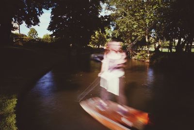 Blurred motion of man in car