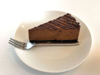 Close-up of cake on table against white background