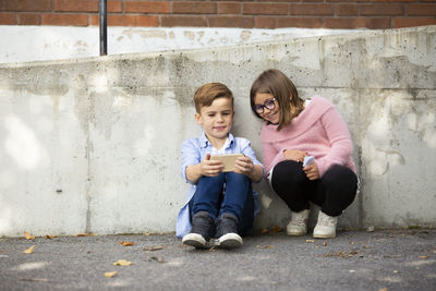 Boy and girl looking at cell phone