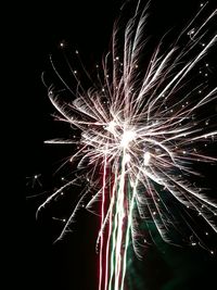 Low angle view of firework display at night