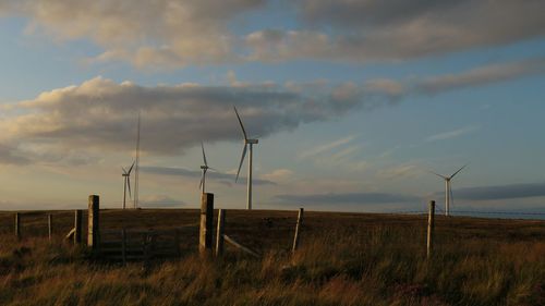 Windmill on field against sky