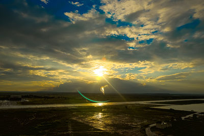 View of sea against cloudy sky during sunset