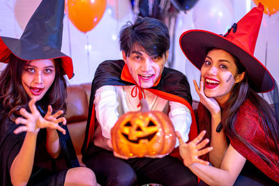 Young woman in traditional clothing holding halloween