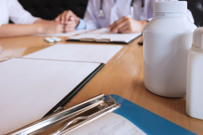 Close-up of people on white table