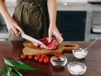 Midsection of woman preparing food on table