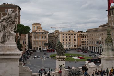 Group of people in city against buildings